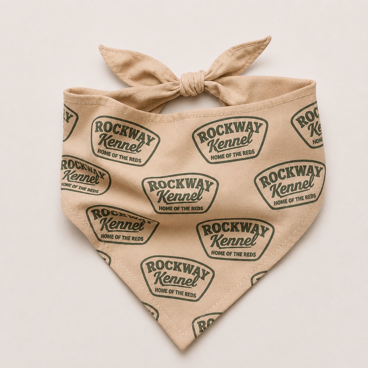 Warm beige Rockway Kennel dog bandana, folded and tied